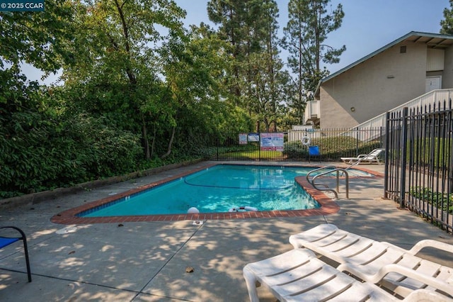 view of swimming pool featuring a patio