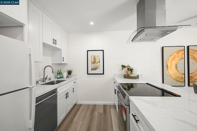 kitchen featuring sink, stainless steel appliances, white cabinets, and island exhaust hood