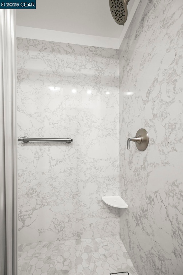 bathroom with tiled shower