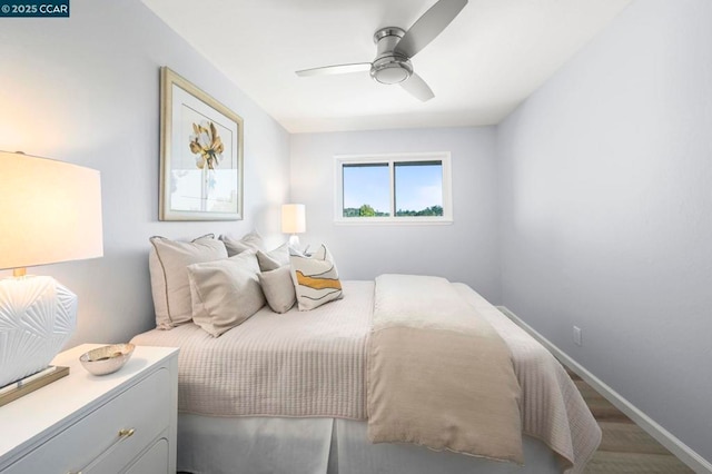 bedroom with hardwood / wood-style floors and ceiling fan