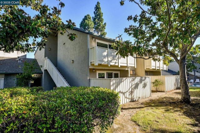 view of property exterior featuring a balcony