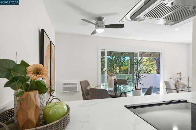 interior space featuring a wall mounted AC and ceiling fan