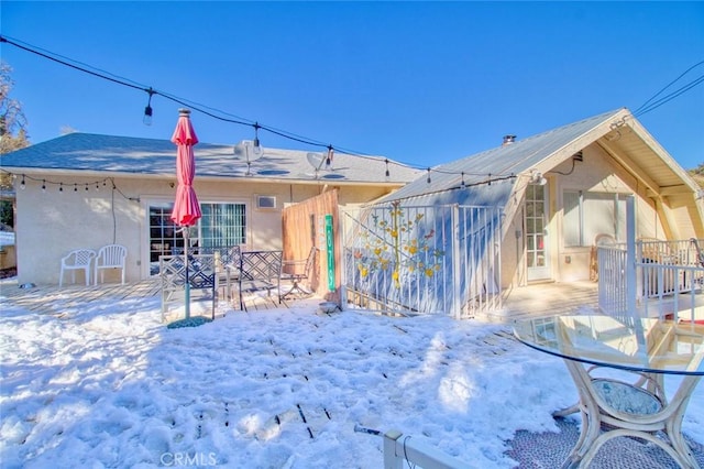 view of snow covered rear of property