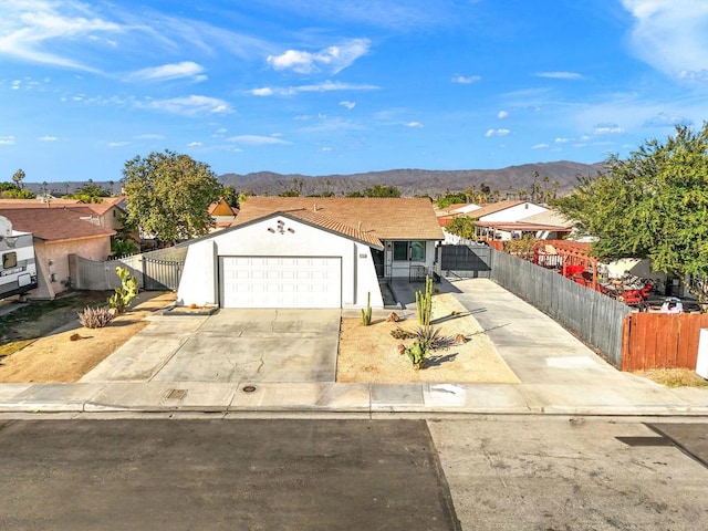 ranch-style house featuring a garage and a mountain view