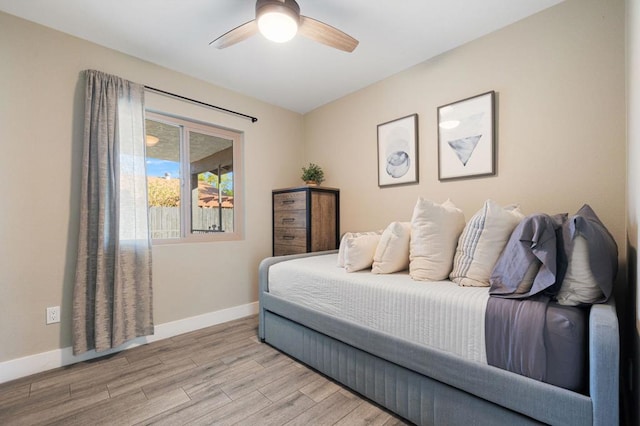 bedroom with ceiling fan and light wood-type flooring