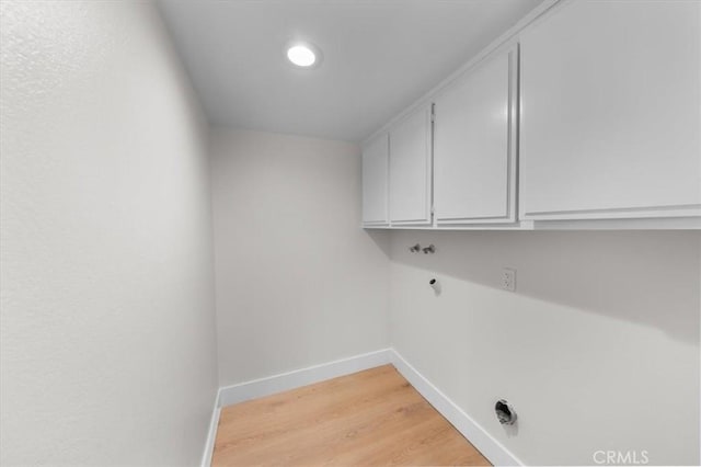 washroom featuring light hardwood / wood-style floors and cabinets