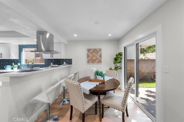 dining room with sink and light hardwood / wood-style floors