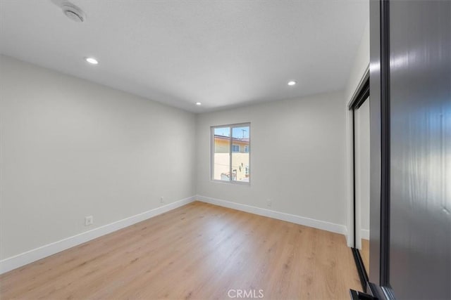 unfurnished bedroom featuring light hardwood / wood-style floors and a closet