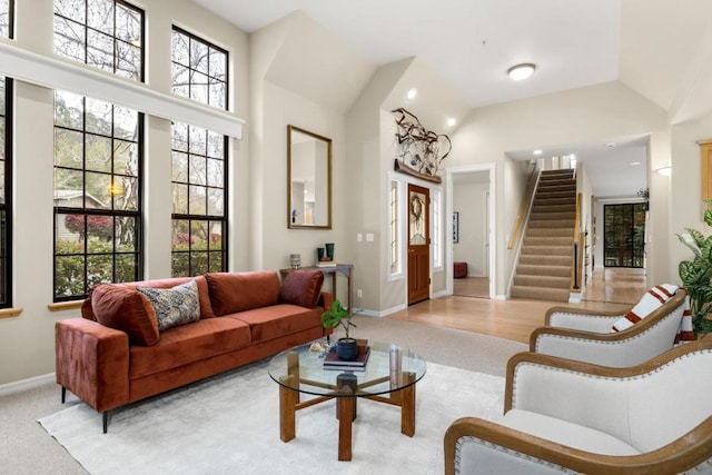 carpeted living room featuring high vaulted ceiling