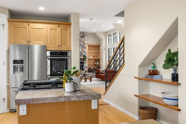 kitchen featuring stainless steel appliances, light brown cabinets, and light hardwood / wood-style flooring