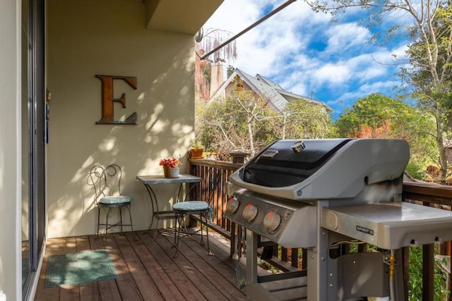 wooden balcony featuring area for grilling and a deck