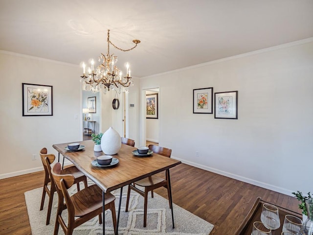 dining room with ornamental molding, dark hardwood / wood-style flooring, and a notable chandelier