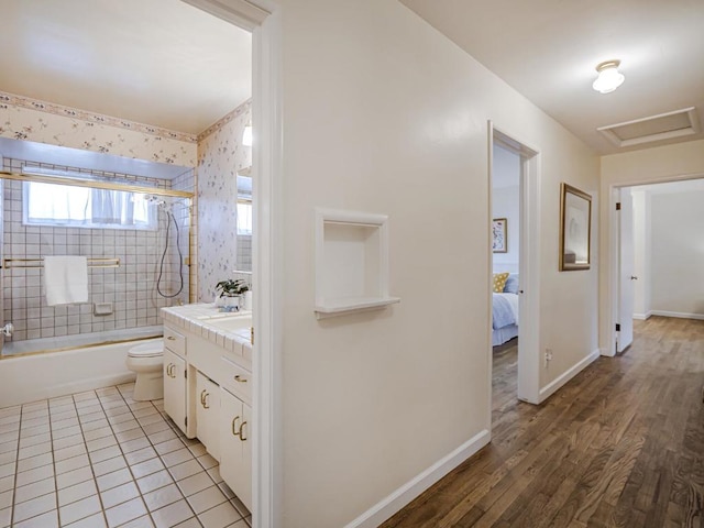 full bathroom featuring vanity, tile patterned floors, toilet, and tiled shower / bath