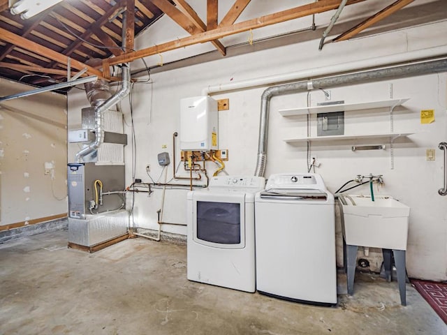 laundry room featuring heating unit, tankless water heater, and washer and dryer