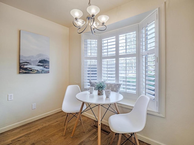 dining area with hardwood / wood-style flooring and a chandelier