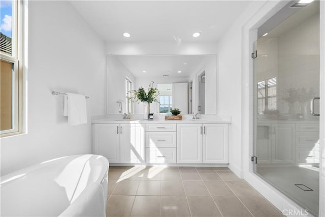 bathroom with vanity, plus walk in shower, and tile patterned flooring