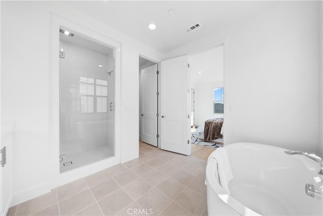 bathroom featuring tile patterned flooring and a shower with shower door