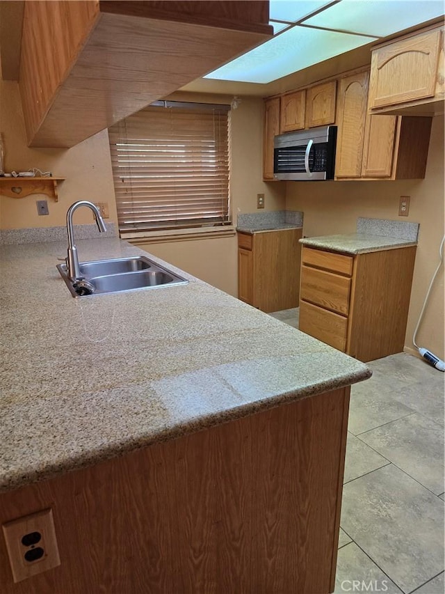 kitchen featuring sink and light tile patterned floors