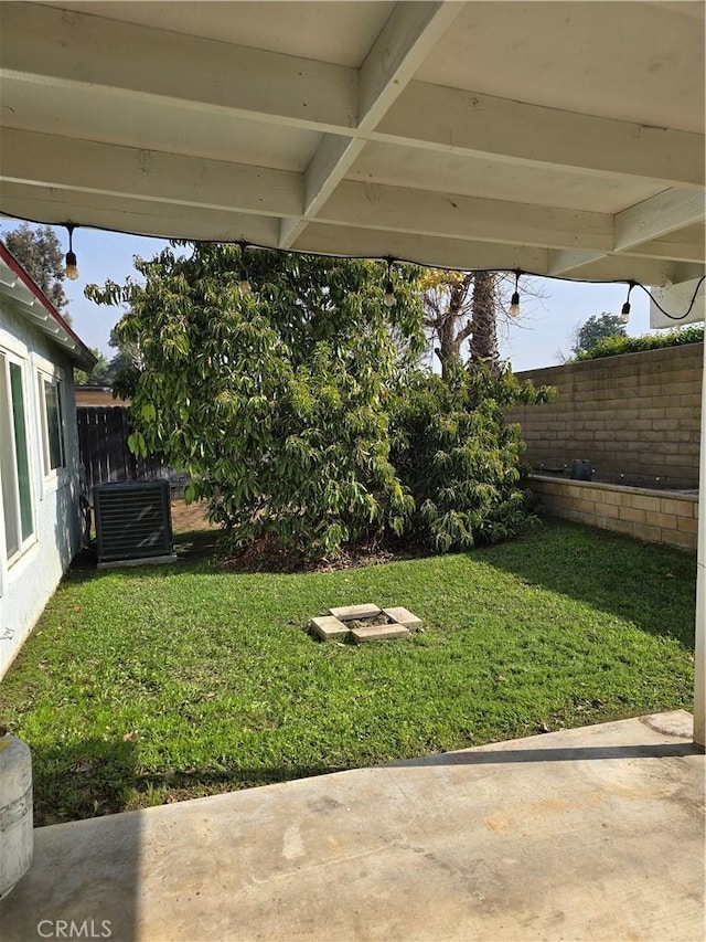 view of yard featuring central AC unit and a patio