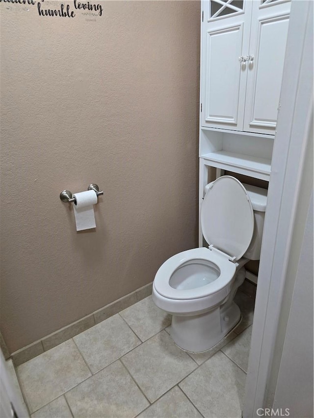 bathroom featuring tile patterned floors and toilet