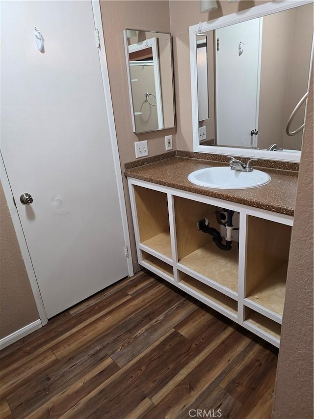 bathroom featuring vanity and wood-type flooring