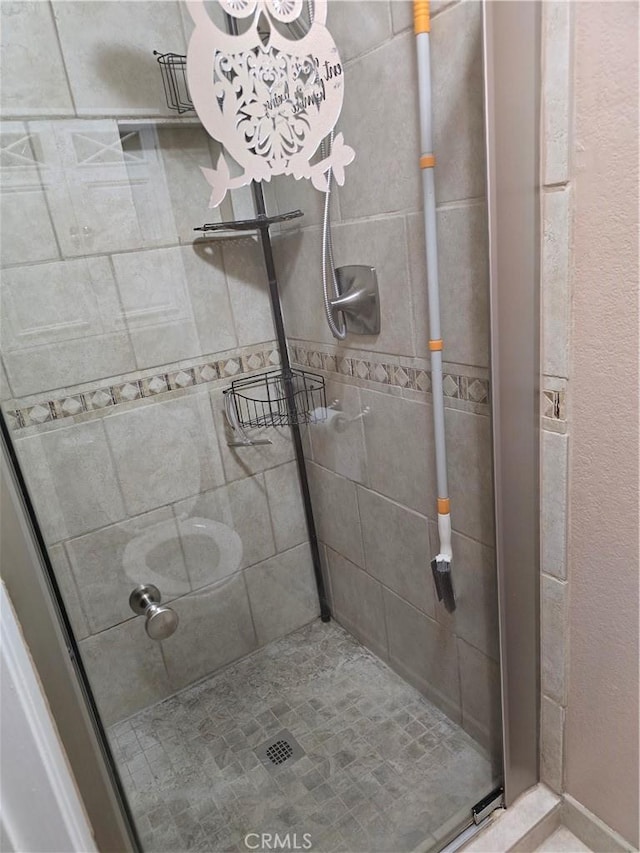 bathroom with a shower with door