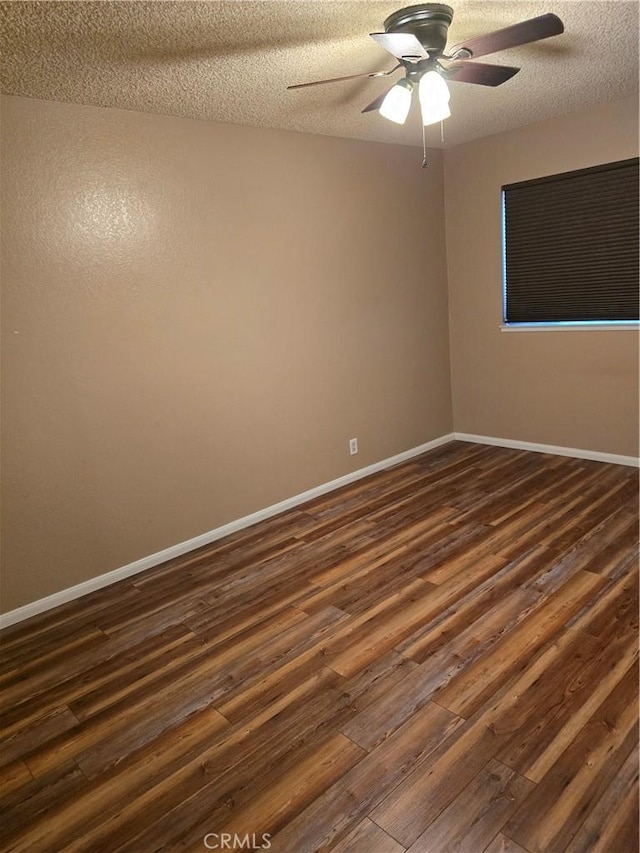 unfurnished room with ceiling fan, dark hardwood / wood-style floors, and a textured ceiling