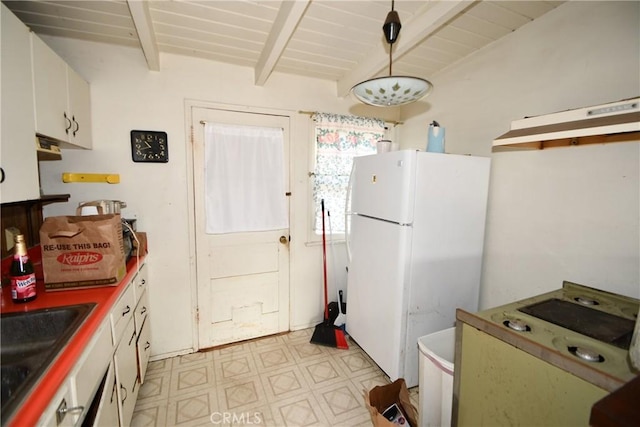 kitchen featuring sink, white cabinetry, hanging light fixtures, white fridge, and beam ceiling