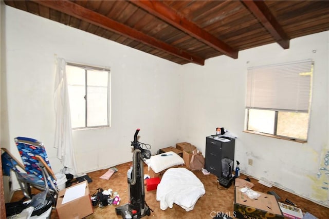 interior space featuring plenty of natural light, beam ceiling, and wooden ceiling