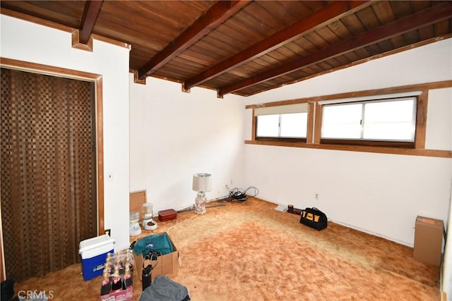 interior space featuring multiple windows, wooden ceiling, and lofted ceiling with beams