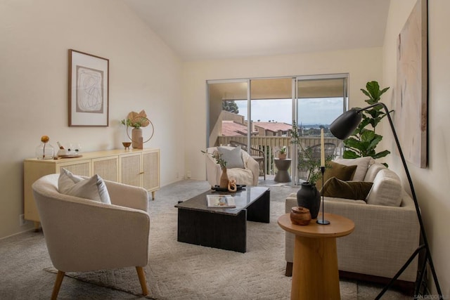 carpeted living room featuring vaulted ceiling