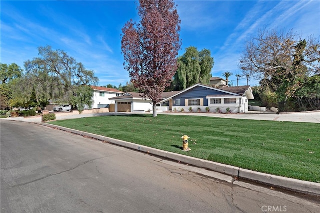 single story home featuring a garage and a front yard