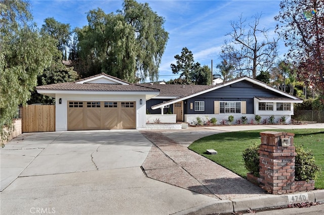 single story home with a garage and a front yard