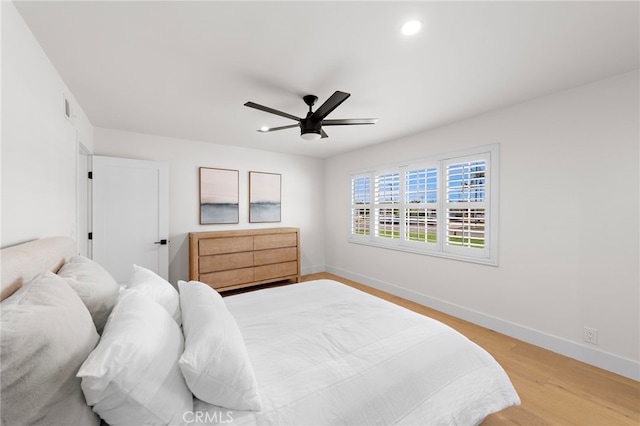 bedroom with ceiling fan and light wood-type flooring