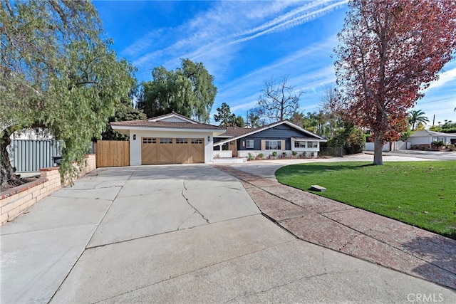 ranch-style house with a garage and a front yard