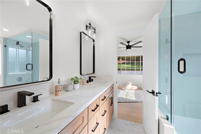 bathroom featuring ceiling fan, vanity, and an enclosed shower