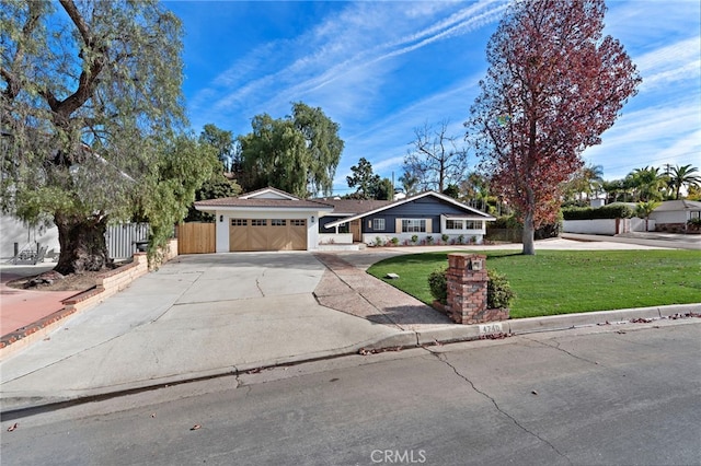 single story home featuring a garage and a front yard