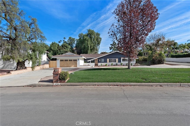 ranch-style house with a garage and a front lawn