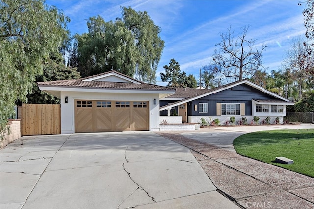 single story home featuring a garage and a front lawn