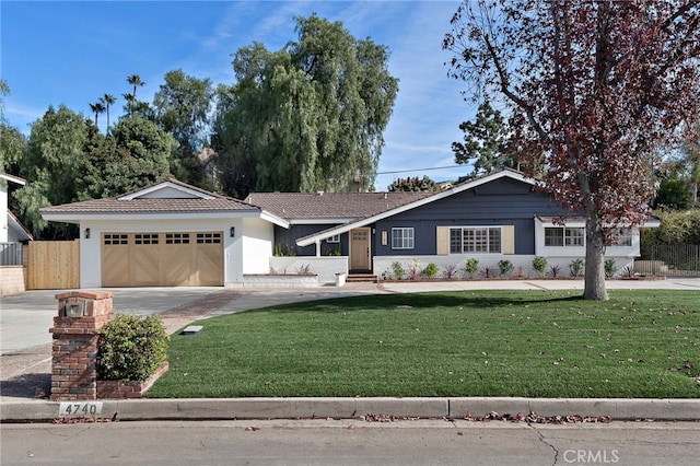 ranch-style house featuring a garage and a front yard