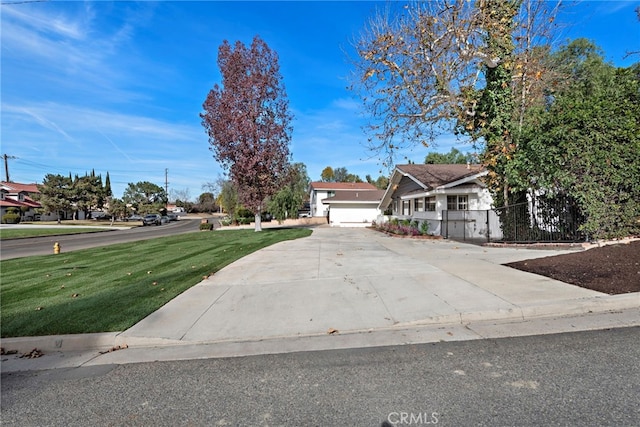 view of front of property featuring a garage and a front yard