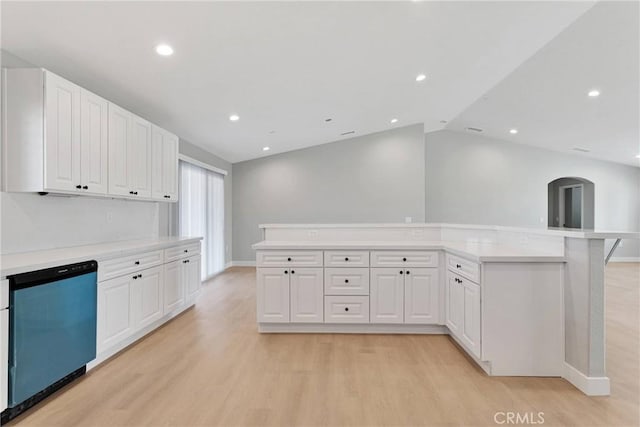 kitchen featuring white cabinets, dishwashing machine, light countertops, and light wood finished floors