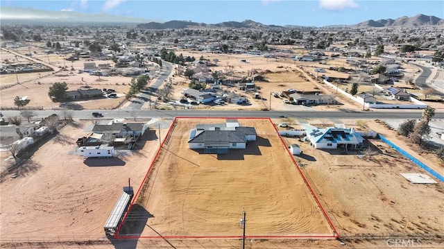 drone / aerial view with a mountain view and view of desert