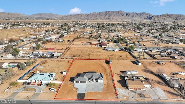 drone / aerial view featuring a desert view and a mountain view