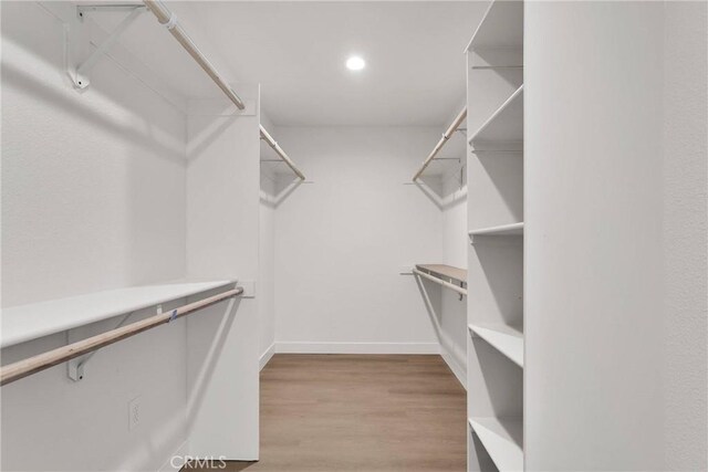 spacious closet with wood finished floors