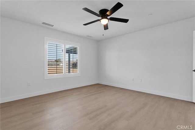 unfurnished room featuring a ceiling fan, baseboards, light wood-style floors, and visible vents