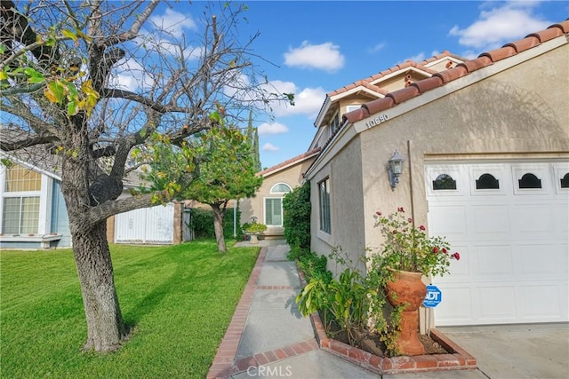 view of home's exterior with a yard and a garage