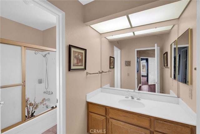 bathroom with vanity and combined bath / shower with glass door