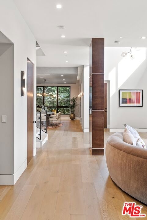 hallway with light hardwood / wood-style flooring