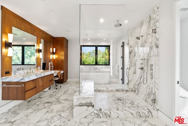 bathroom featuring vanity and shower with separate bathtub